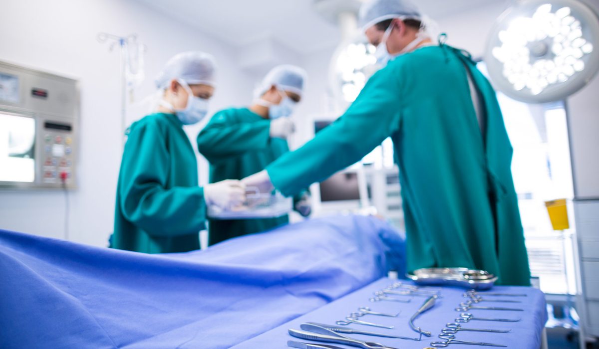 Surgeons performing operation in operation theater of hospital